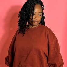 Load image into Gallery viewer, Black girl in cinnamon colored jogger set standing in front of a pink background.

