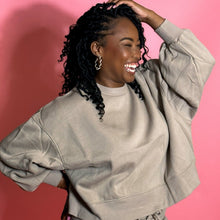 Load image into Gallery viewer, black girl smiling and wearing oatmeal colored joggers in front of a pink background.
