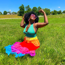 Load image into Gallery viewer, a black model is wearing a rainbow halter tiered maxi dress outside in the grass
