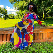 Load image into Gallery viewer, black woman with afro outside in park wearing an off the shoulder colorful mixed print maxi dress
