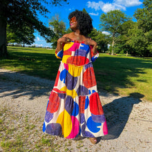 Load image into Gallery viewer, black woman with afro outside in park wearing an off the shoulder colorful mixed print maxi dress
