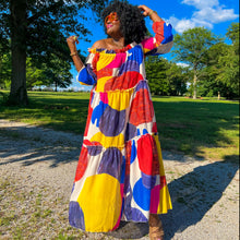 Load image into Gallery viewer, black woman with afro outside in park wearing an off the shoulder colorful mixed print maxi dress
