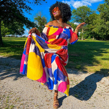 Load image into Gallery viewer, black woman with afro outside in park wearing an off the shoulder colorful mixed print maxi dress
