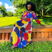 Load image into Gallery viewer, black woman with afro outside in park wearing an off the shoulder colorful mixed print maxi dress
